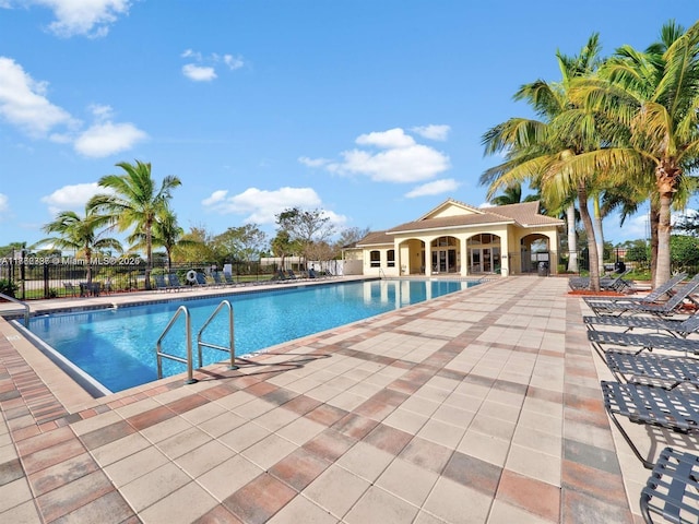 pool featuring a patio and fence