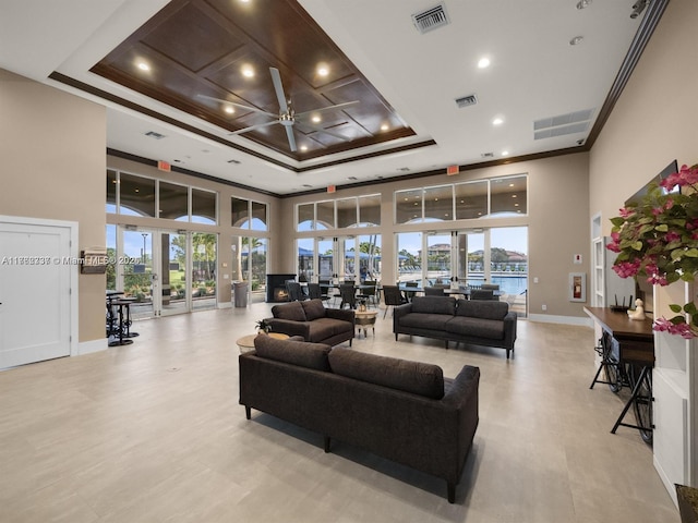 living room with visible vents, french doors, and a raised ceiling