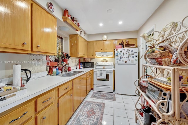 kitchen with under cabinet range hood, light countertops, light tile patterned flooring, white appliances, and a sink