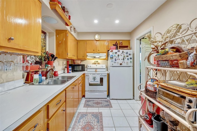 kitchen with white appliances, light tile patterned flooring, a sink, light countertops, and under cabinet range hood