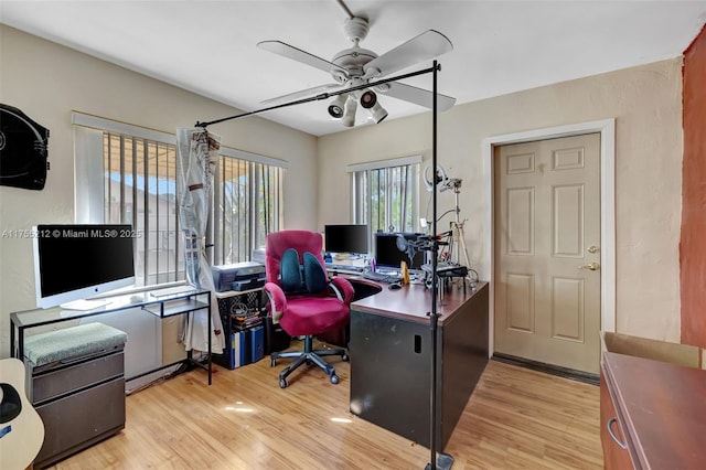 office with light wood-style flooring and ceiling fan