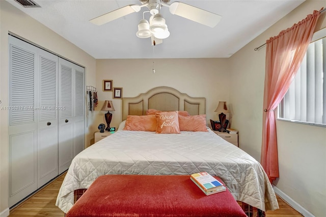 bedroom with light wood-style flooring, baseboards, a closet, and ceiling fan