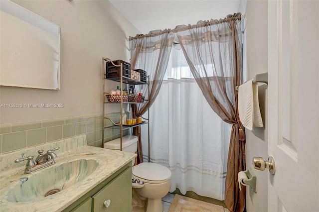 bathroom featuring vanity, tile walls, toilet, and a shower with curtain