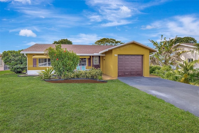 ranch-style home with a garage, aphalt driveway, a front yard, and stucco siding