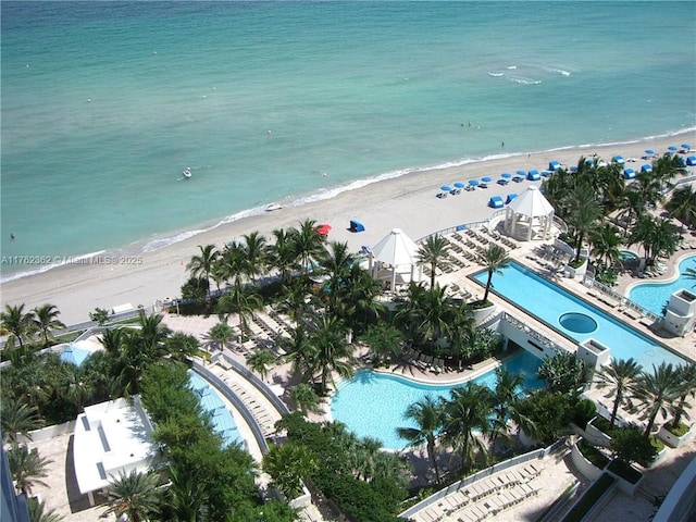 bird's eye view featuring a water view and a beach view