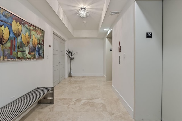 hallway with visible vents and baseboards