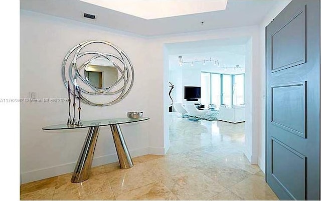 hallway featuring visible vents and baseboards