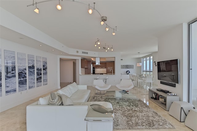 living room featuring visible vents and track lighting