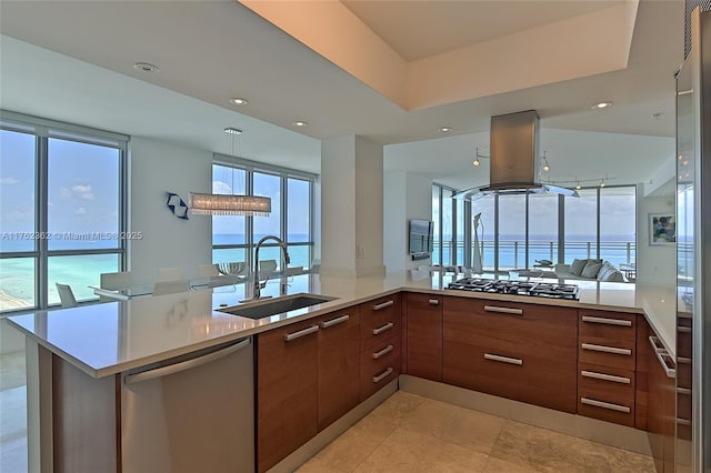 kitchen featuring gas stovetop, stainless steel dishwasher, island range hood, modern cabinets, and a sink