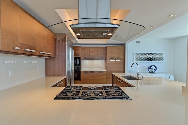 kitchen featuring brown cabinetry, black appliances, modern cabinets, and a sink