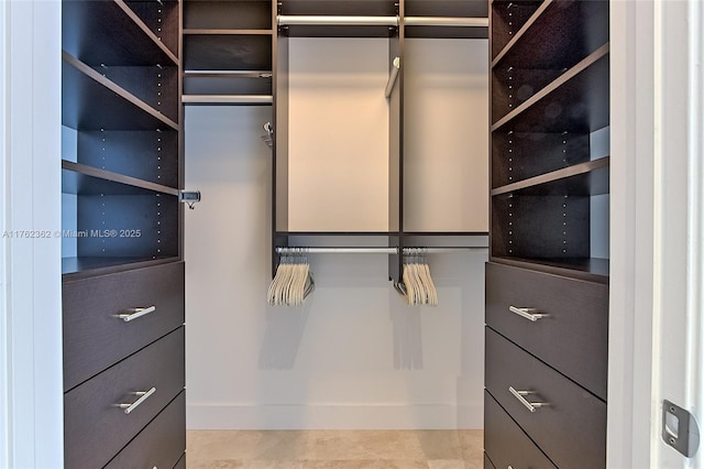 spacious closet featuring tile patterned flooring