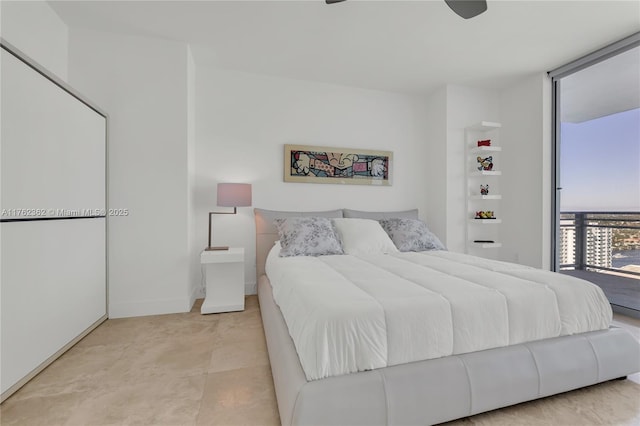 bedroom with a wall of windows and baseboards