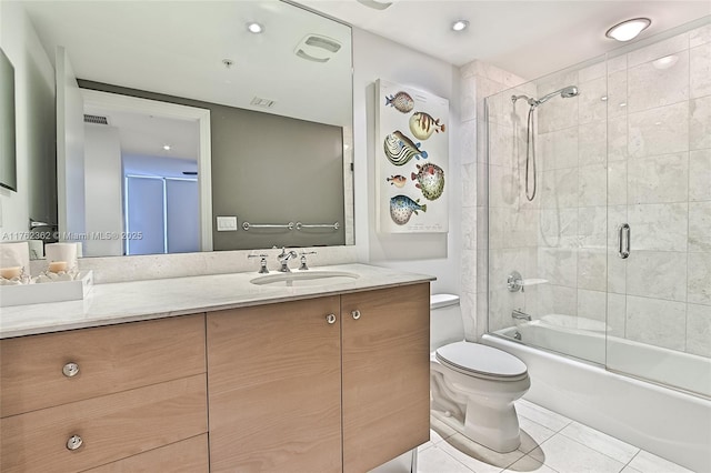 bathroom featuring vanity, visible vents, shower / bath combination with glass door, tile patterned flooring, and toilet