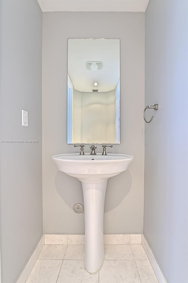 bathroom featuring baseboards and tile patterned flooring