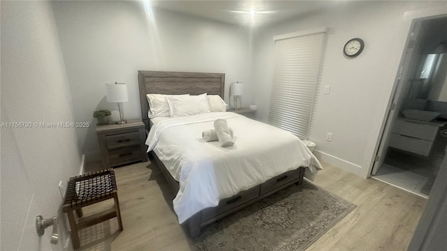 bedroom with baseboards and light wood finished floors