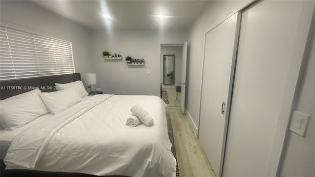 bedroom featuring light wood-type flooring and a closet