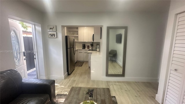 interior space with light wood-style flooring and baseboards