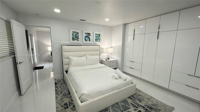 bedroom featuring light tile patterned floors, visible vents, and recessed lighting