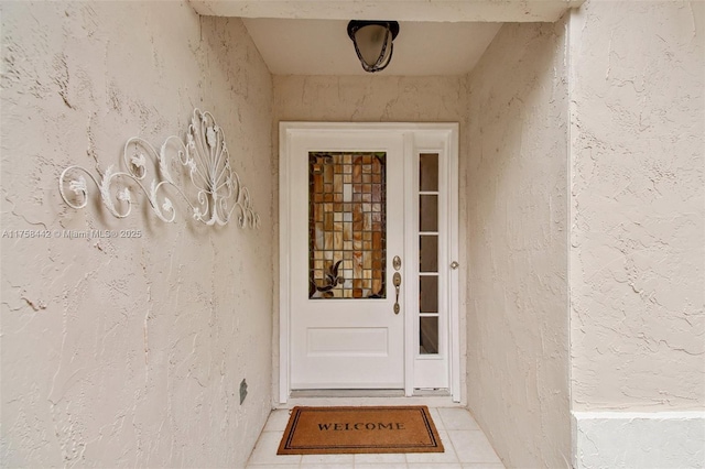 entrance to property with stucco siding