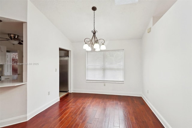 unfurnished dining area with an inviting chandelier, baseboards, lofted ceiling, and wood finished floors