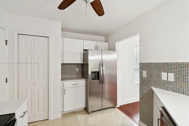 kitchen with light countertops, white cabinets, and stainless steel fridge