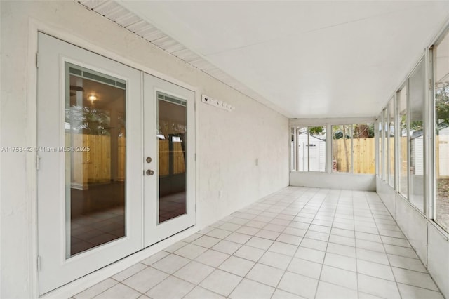 unfurnished sunroom with french doors