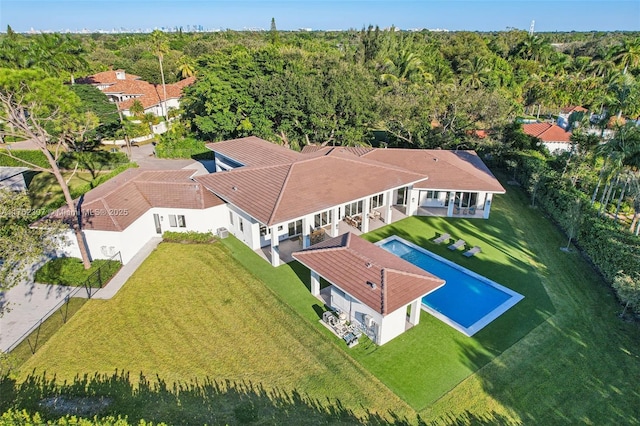 drone / aerial view featuring a wooded view