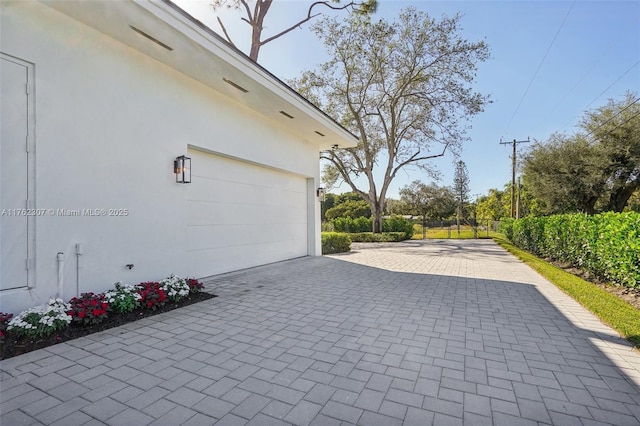 garage featuring decorative driveway