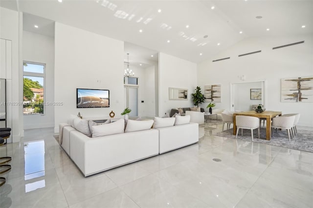 living room featuring a chandelier and high vaulted ceiling