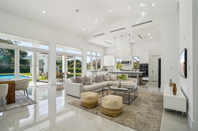 living area featuring recessed lighting, french doors, marble finish floor, and high vaulted ceiling