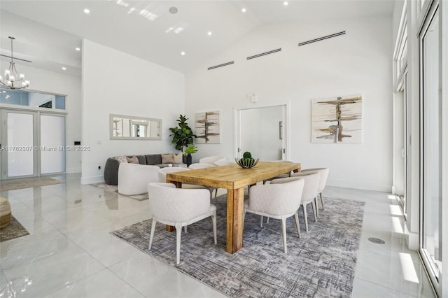 dining space with a chandelier, recessed lighting, high vaulted ceiling, and baseboards