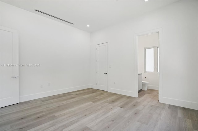 unfurnished bedroom featuring light wood-type flooring, visible vents, ensuite bath, recessed lighting, and baseboards