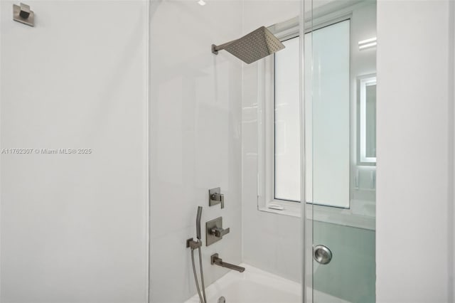 bathroom featuring bath / shower combo with glass door