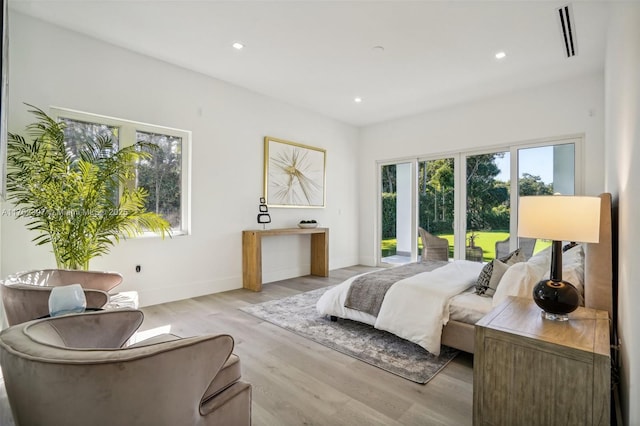 bedroom featuring recessed lighting, light wood-type flooring, baseboards, and access to exterior