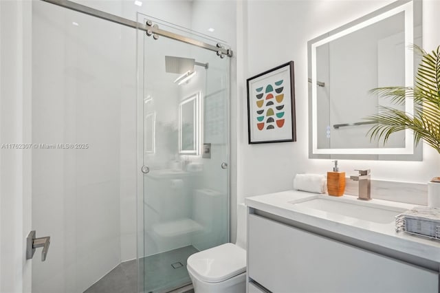 bathroom featuring vanity, toilet, and a stall shower