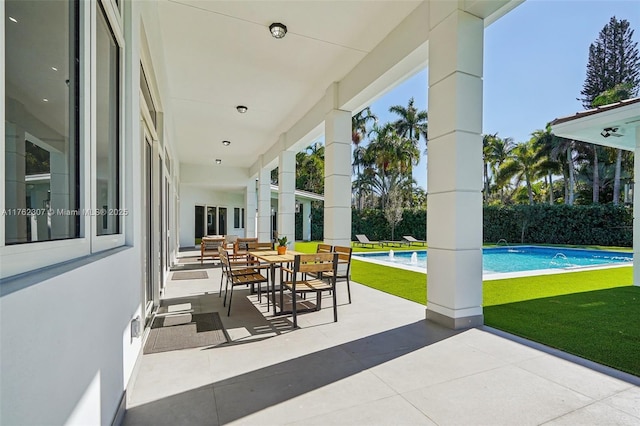 view of patio with a fenced in pool