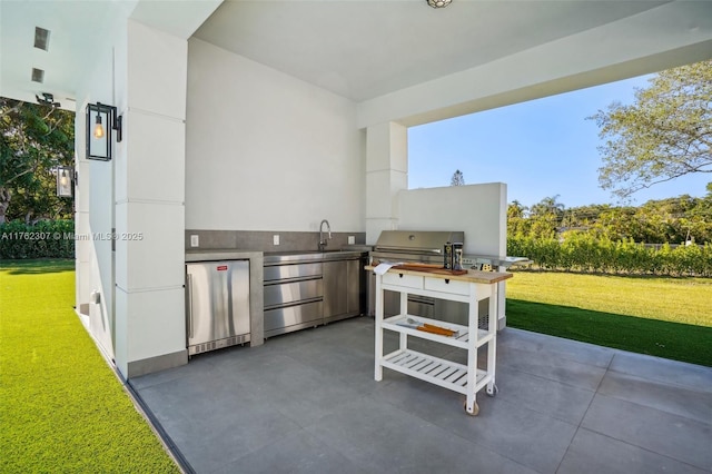 view of patio featuring an outdoor kitchen and a sink