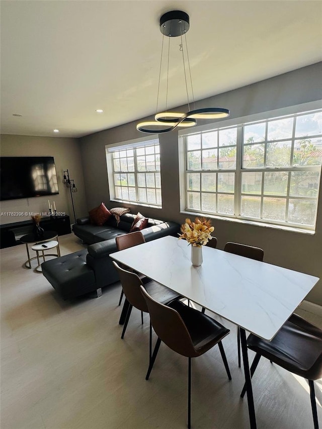 dining room with recessed lighting and light wood-type flooring