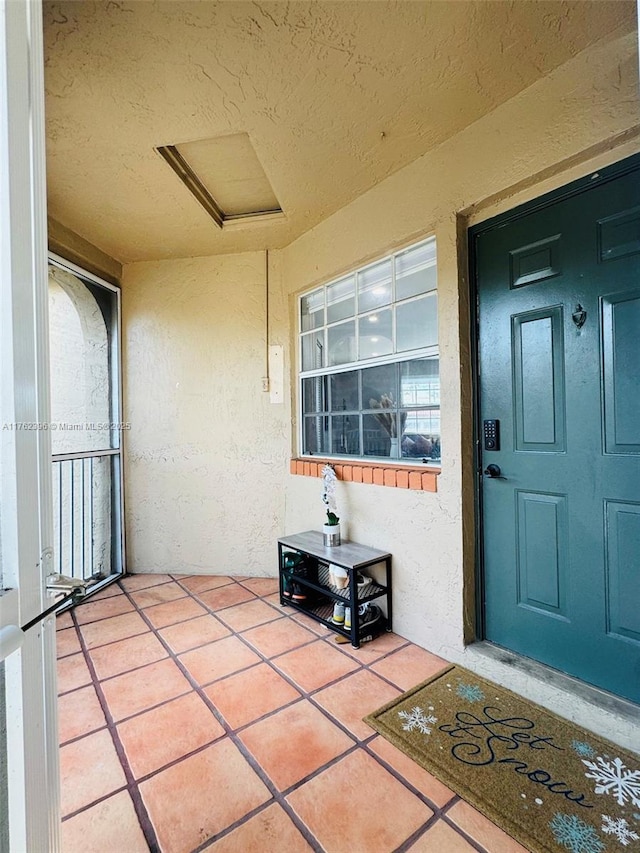 entrance to property featuring stucco siding