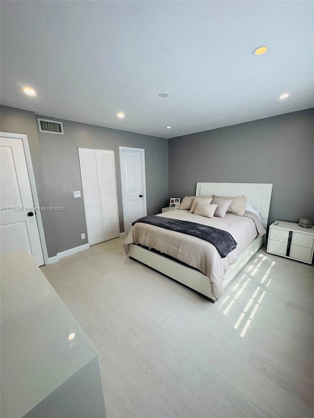 bedroom with baseboards, recessed lighting, visible vents, and light wood-type flooring