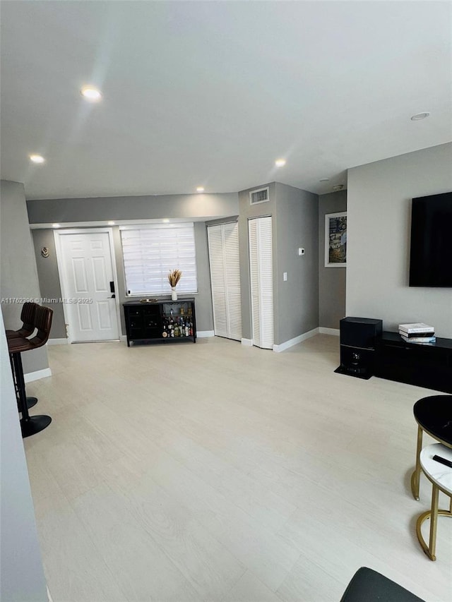 living room with recessed lighting, baseboards, and visible vents