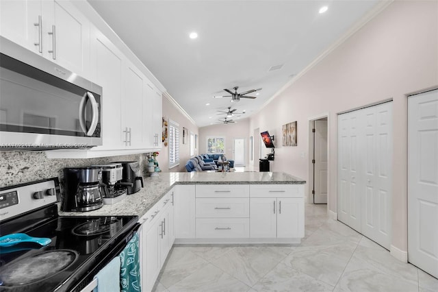 kitchen with crown molding, white cabinets, appliances with stainless steel finishes, a peninsula, and marble finish floor