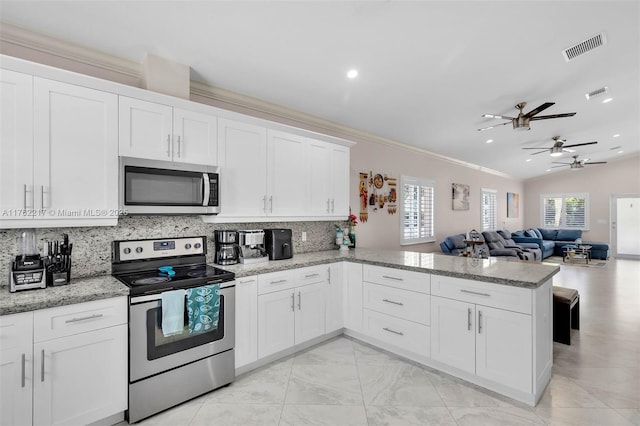 kitchen featuring visible vents, ornamental molding, decorative backsplash, stainless steel appliances, and white cabinetry