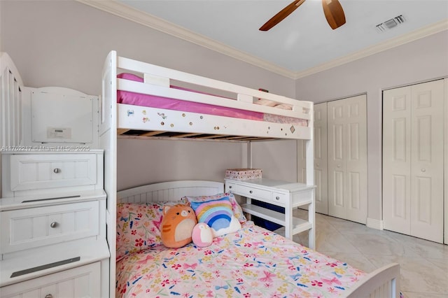 bedroom featuring ceiling fan, visible vents, two closets, and ornamental molding