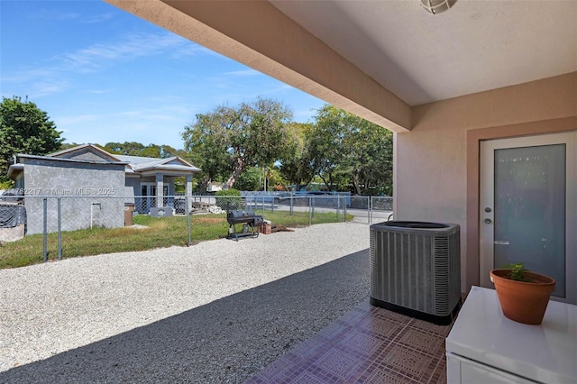 view of patio / terrace featuring fence and central AC