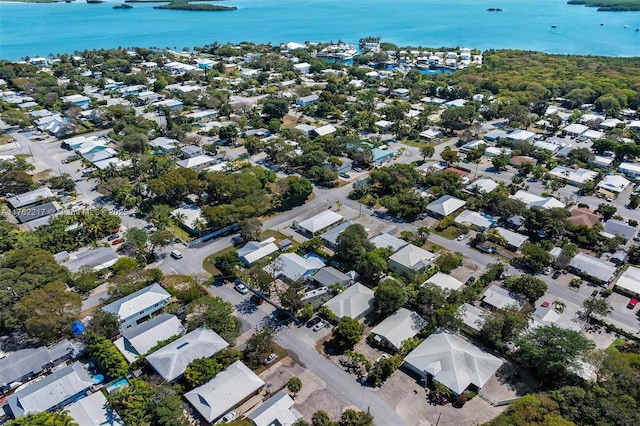 drone / aerial view featuring a residential view and a water view