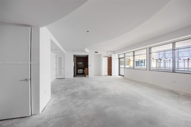 unfurnished living room with concrete floors