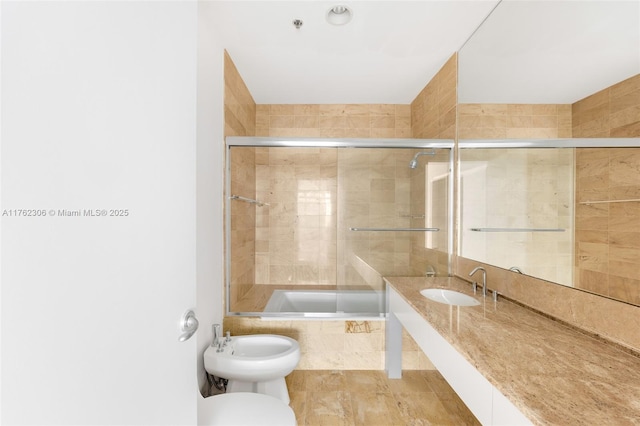 full bathroom featuring tiled shower / bath combo, toilet, a bidet, and a sink