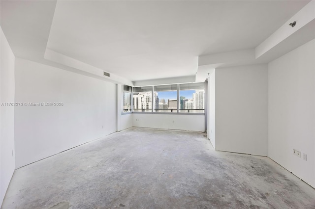 empty room featuring unfinished concrete flooring and visible vents