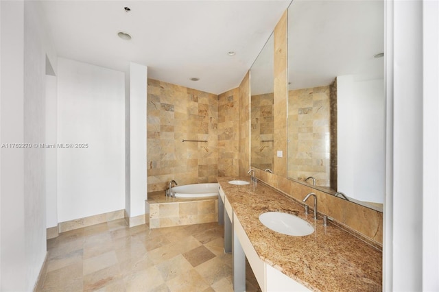 1395 Brickell Ave Unit 3411, Miami, FL 33131 - bathroom featuring double vanity, a bath, baseboards, and a sink